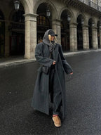 Long hooded dark gray pinstripe coat with double-breasted buttons and side pockets