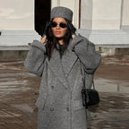 Long hooded dark gray double-breasted coat with textured fabric and side pockets