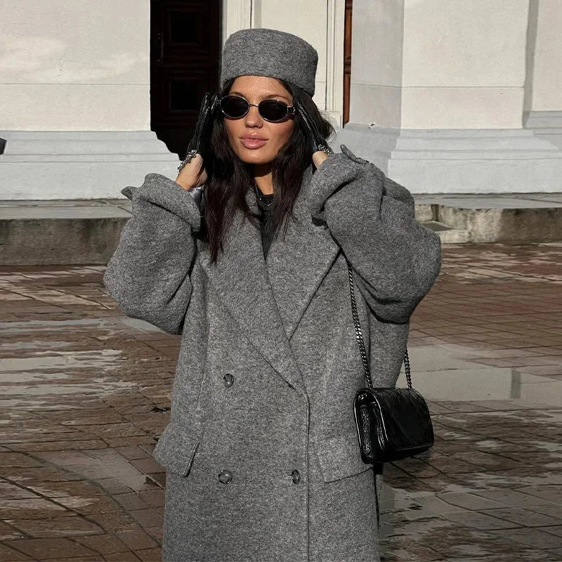 Long hooded dark gray double-breasted coat with textured fabric and side pockets
