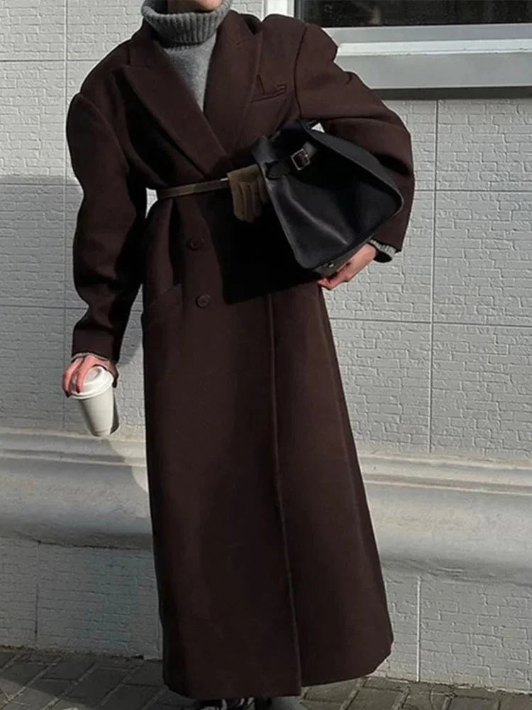 Women’s long brown coat with notched lapels and front button closure