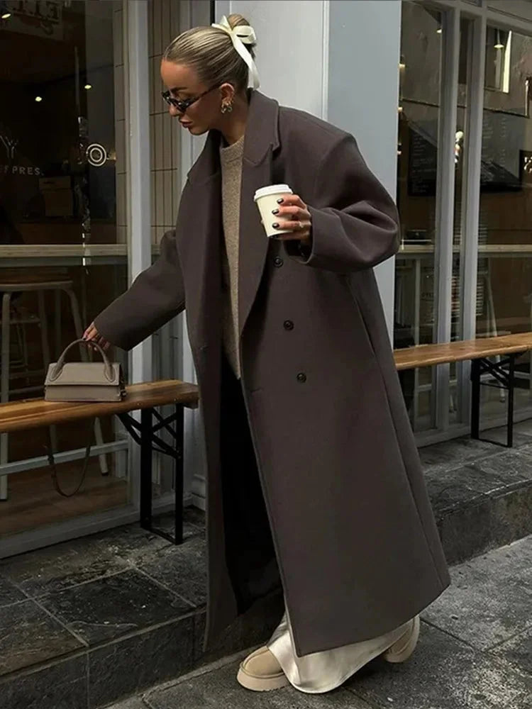 Women’s long taupe coat with notched lapels, button closure, and side pockets