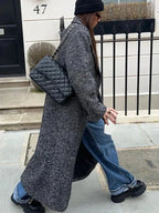 Women’s long gray speckled coat with long sleeves and deep front slit