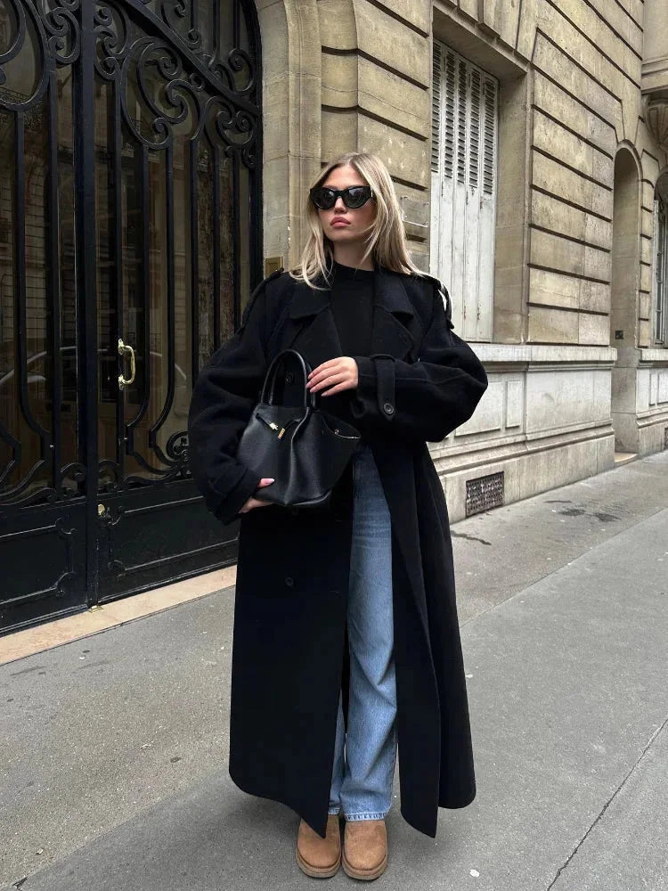 Women's long black belted coat with wide lapels and button front