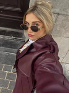 Burgundy trench coat with belt tie, lapels, and long sleeves
