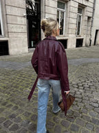Burgundy short trench coat with belt tie, back view
