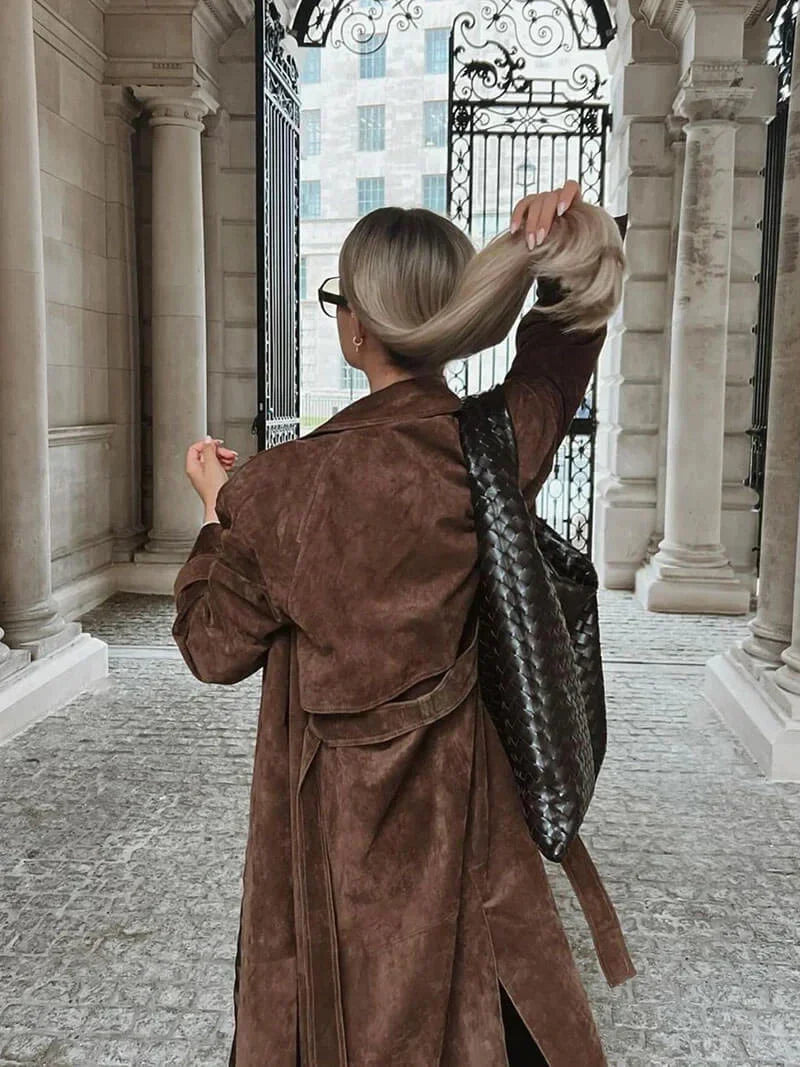 Brown womens trench coat, back view with belt and flap detail