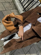Brown womens trench coat with lapels and matching belt, front shown open