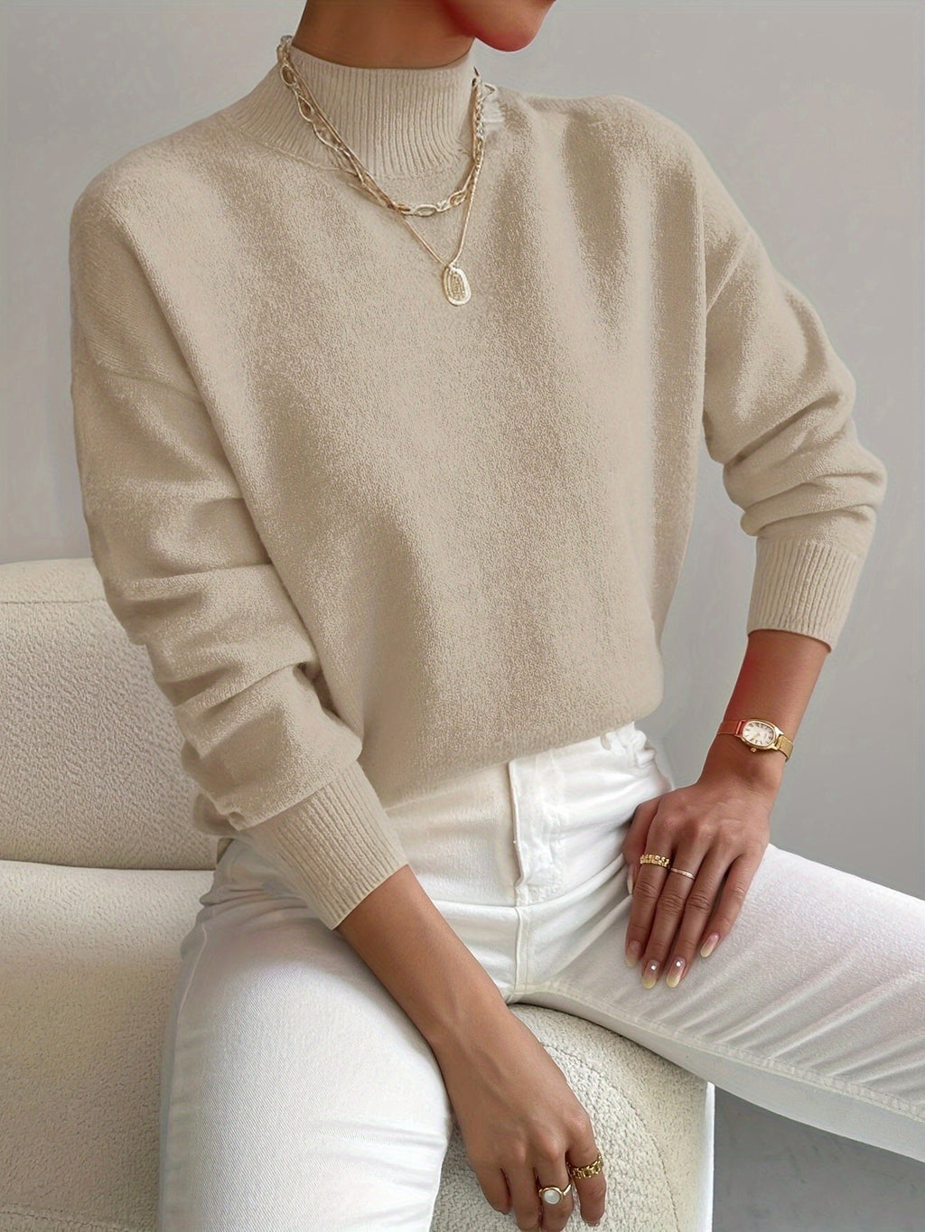 Beige women’s crew-neck sweater with ribbed cuffs and hem
