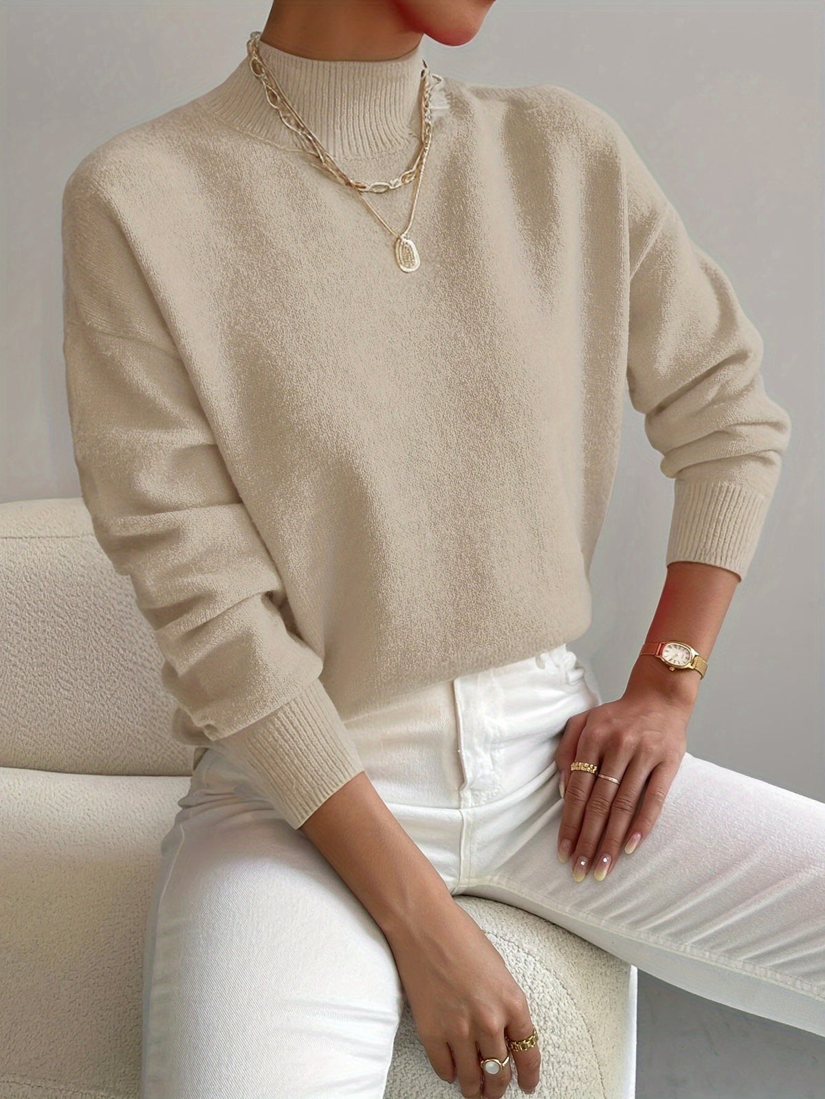 Beige women’s crew-neck sweater with ribbed cuffs and hem