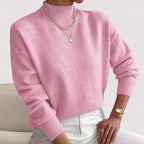 Light pink women’s loose-fit sweater, crew neck, long sleeves, ribbed cuffs and hem.