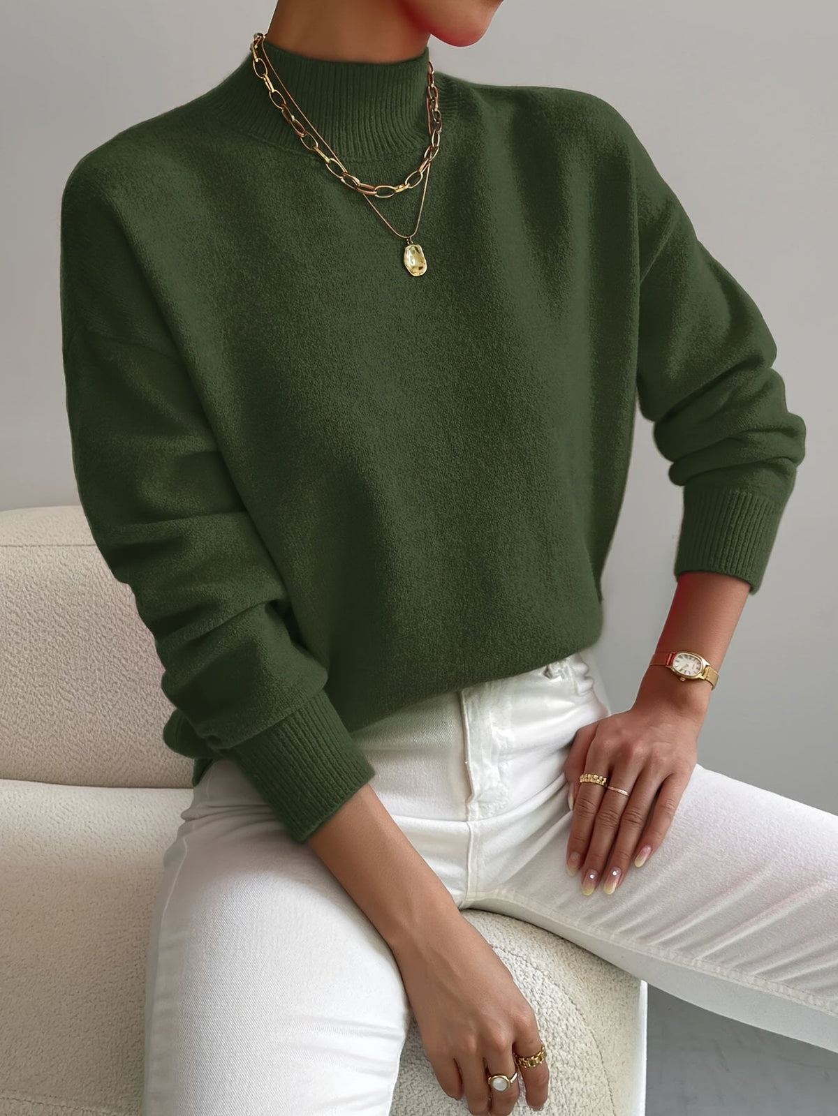 Green women’s crew-neck sweater with ribbed cuffs and hem