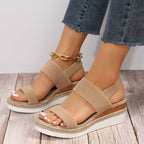 Tan platform sandals with textured elastic straps and open toe, espadrille-style sole