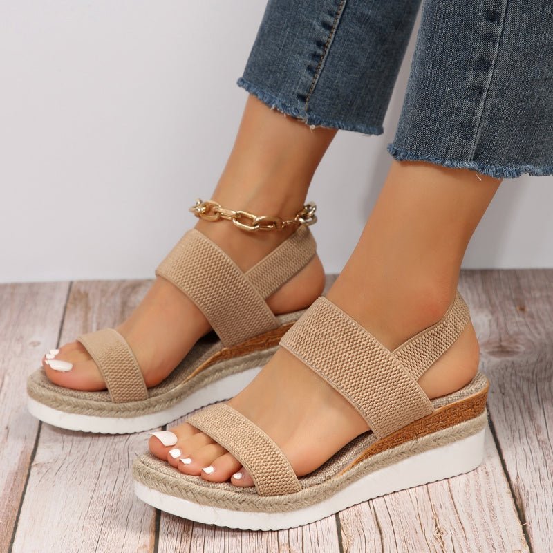 Tan platform sandals with textured elastic straps and open toe, espadrille-style sole