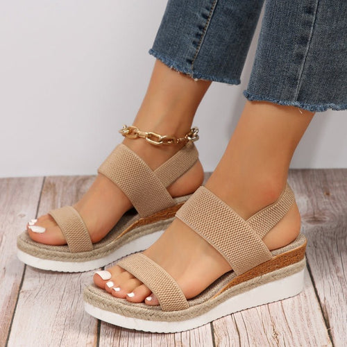 Tan platform sandals with textured elastic straps and open toe, espadrille-style sole