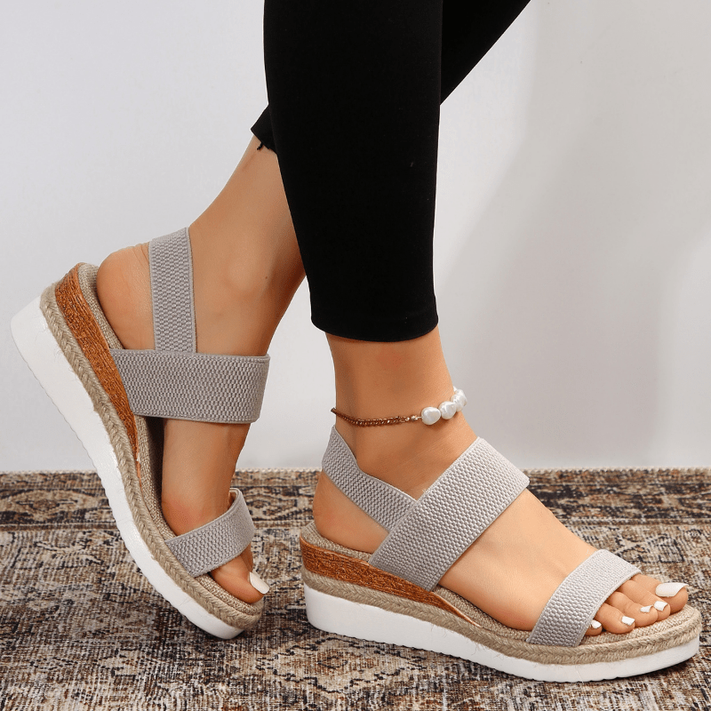 Grey platform sandals with elastic ankle and toe straps, textured jute-look sole