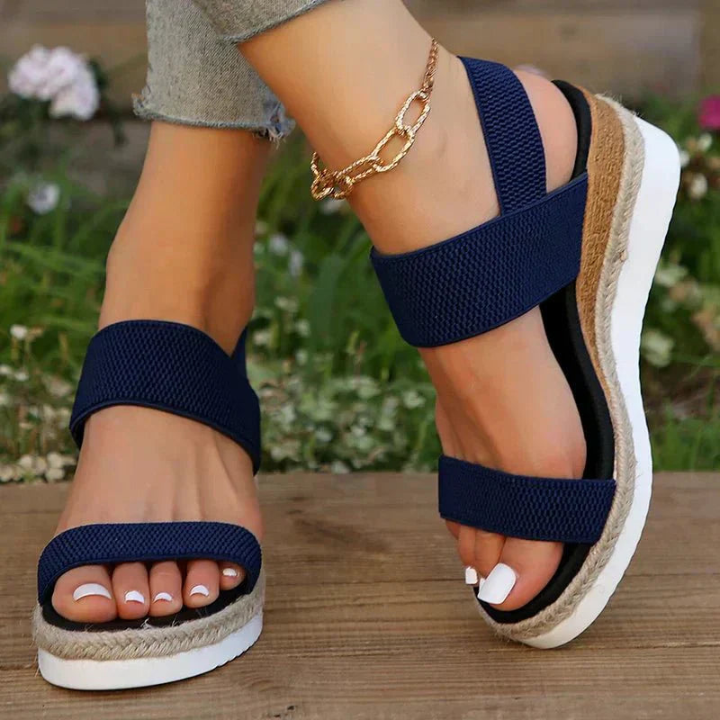 Navy blue platform sandals with elastic straps and open toe, espadrille-style platform