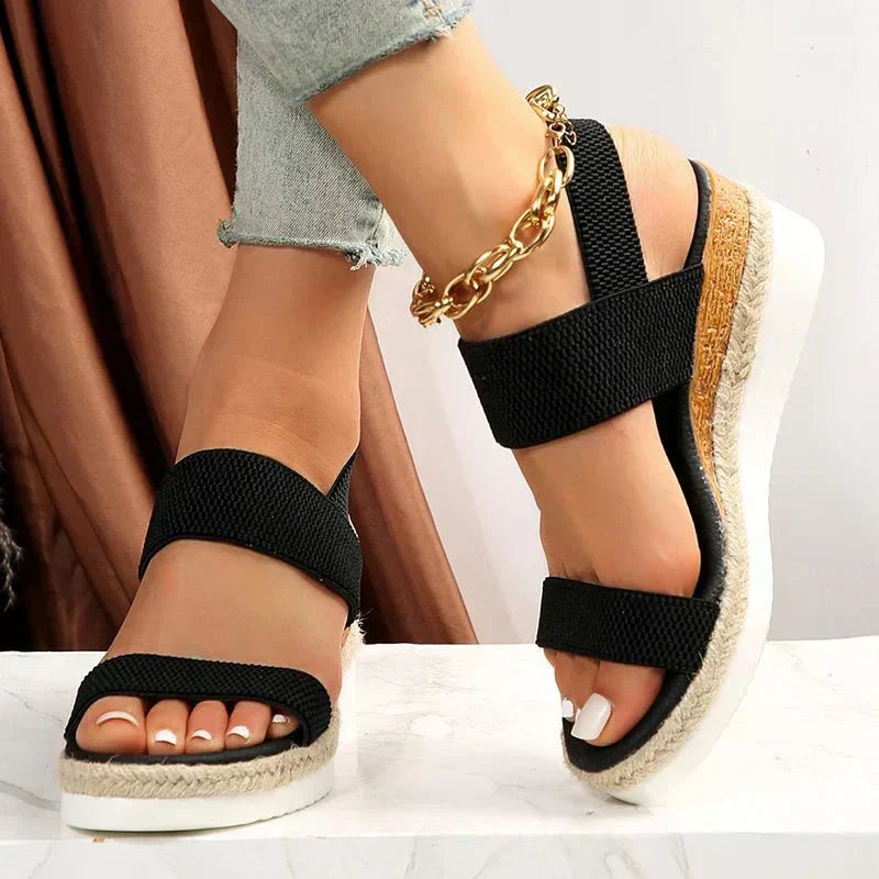 Black platform sandals with elastic straps and open toe, espadrille platform sole