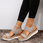 Light grey platform sandals with textured elastic straps and open toe, espadrille sole