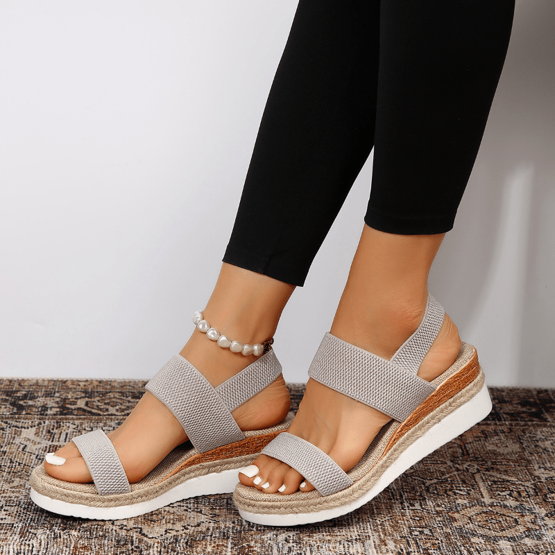 Light grey platform sandals with textured elastic straps and open toe, espadrille sole