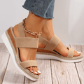 Beige platform sandals with elastic straps and gold chain ankle strap, open toe
