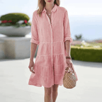 Pink striped mini dress with button front, collared neckline, tiered ruffle skirt.