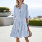 Blue striped mini dress with button front, collared neckline, tiered ruffle skirt.
