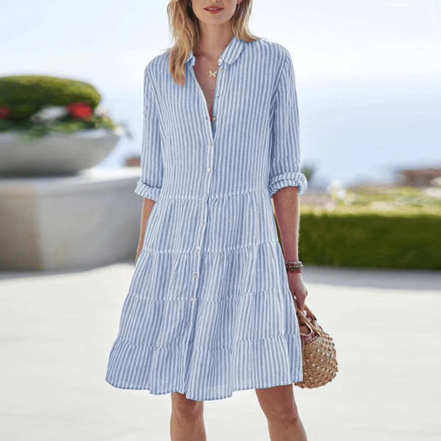Blue striped mini dress with button front, collared neckline, tiered ruffle skirt.