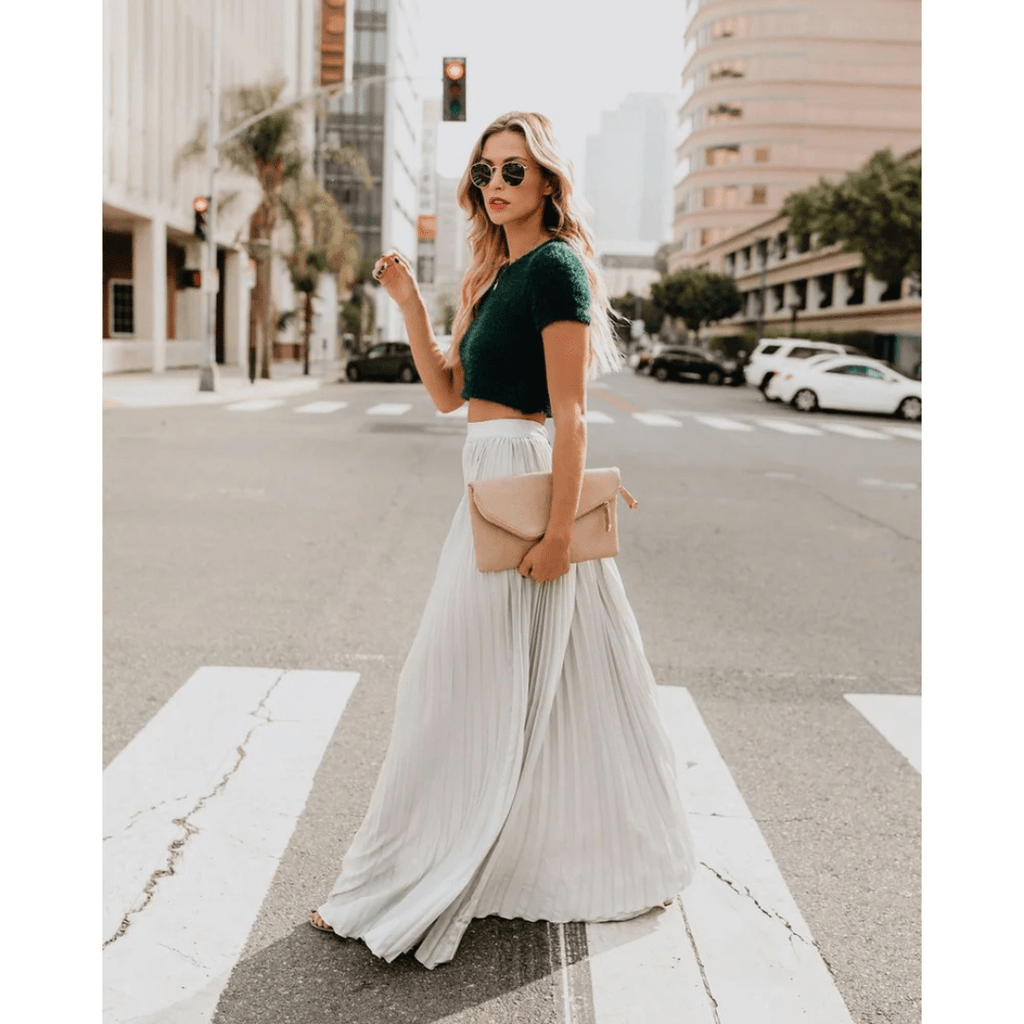 White pleated maxi skirt with elastic waistband and flowing A-line silhouette