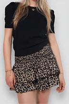 Leopard print tiered mini skirt with smocked waistband and ruffle layers