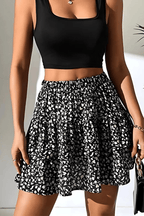 Leilani tiered mini skirt in black-and-white speckled print with gathered ruffle tiers.