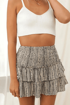 Leilani tiered mini skirt, black-and-white patterned tiers with smocked waistband.