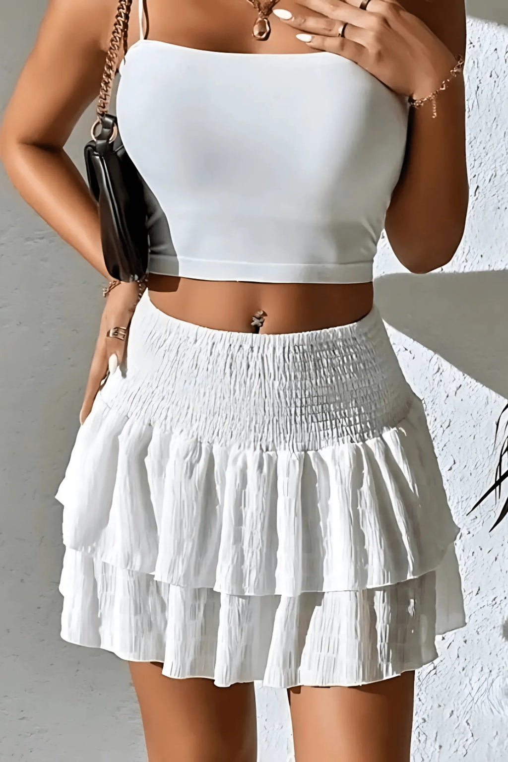 White tiered mini skirt with layered ruffle skirt panels and elastic waist