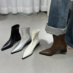 Four pointed-toe ankle boots: black, silver, white, and brown block heels