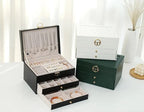 Green leather multilayer jewelry box set with open lid, drawers, and stacked compartments