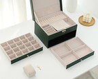 Green multilayer leather jewelry box open with compartment trays and ring insert