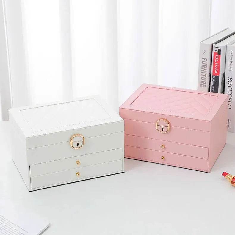 Two multilayer leather jewelry boxes: white and pink with gold locks and two drawers