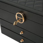 Black leather multilayer jewelry box close-up with gold lock and drawer knobs
