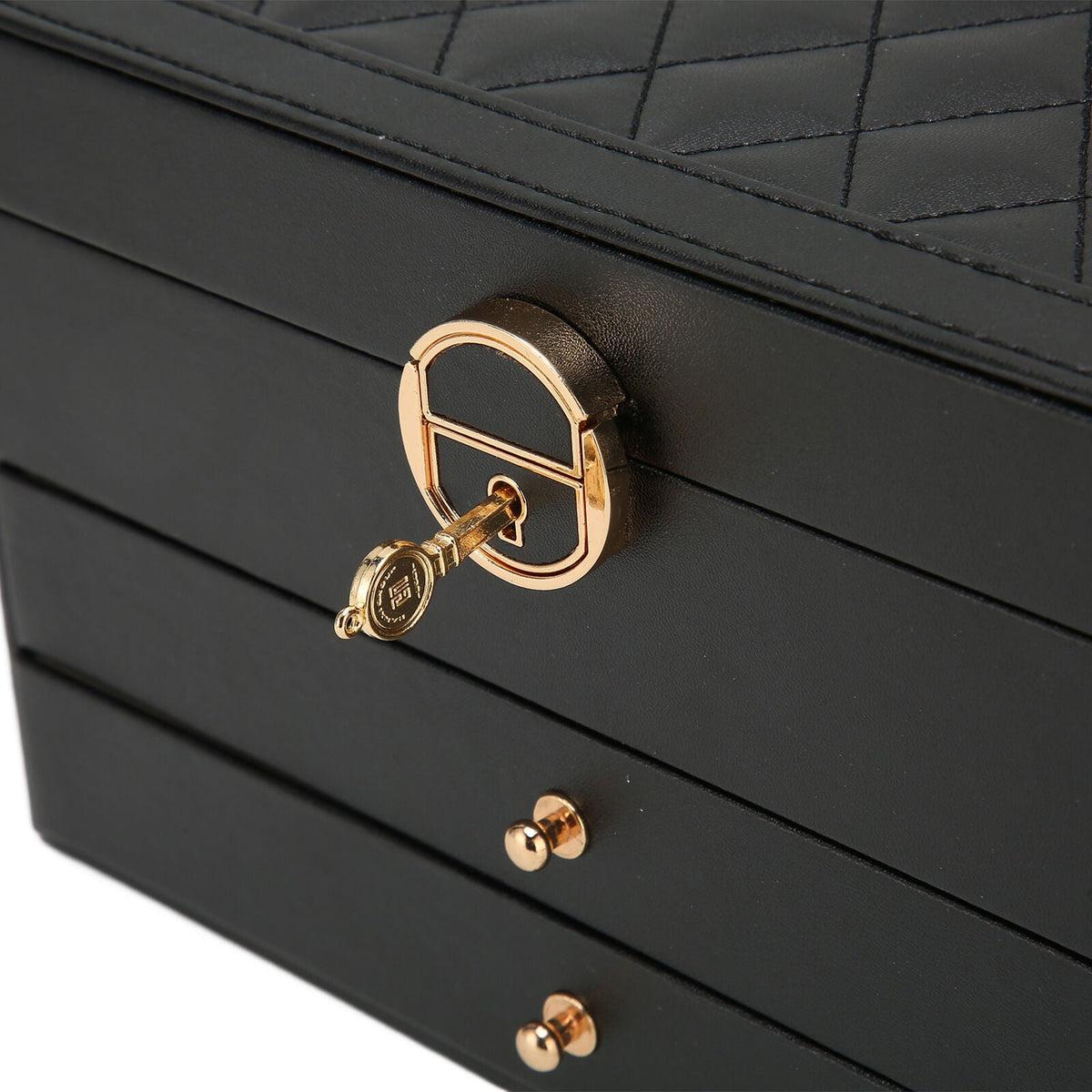 Black leather multilayer jewelry box close-up with gold lock and drawer knobs