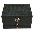 Black leather jewelry box with quilted top and round gold key lock