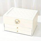 White multilayer leather jewelry box with quilted lid, gold lock, and two drawers