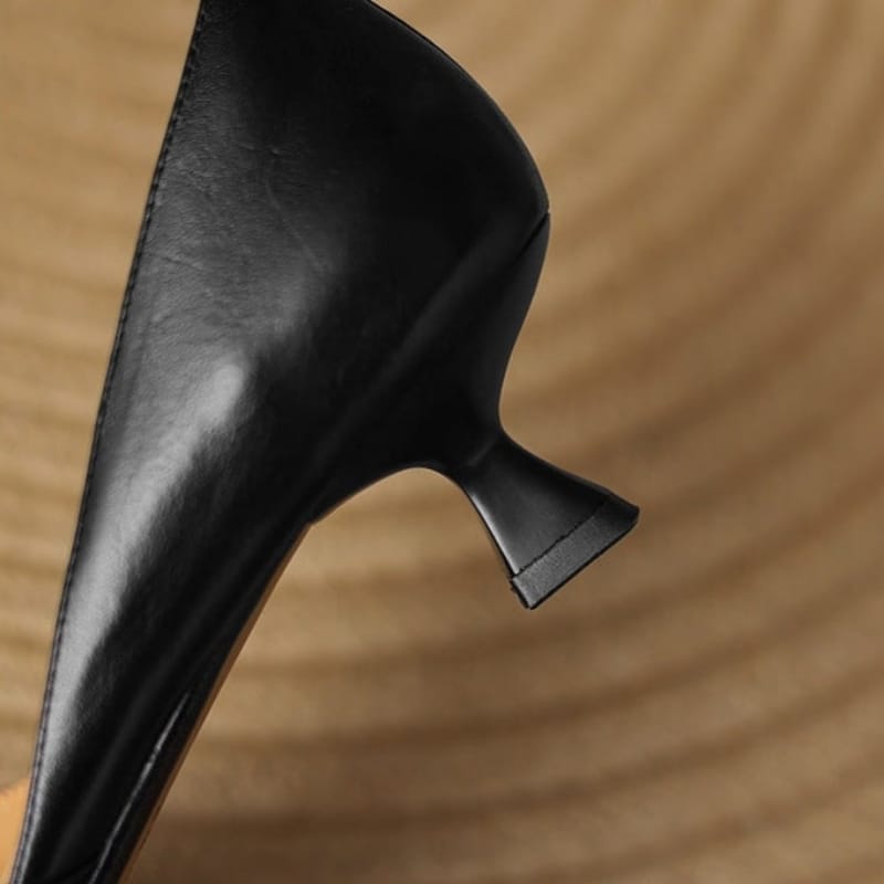 Black pointed-toe kitten heels, angled side view with low block heel