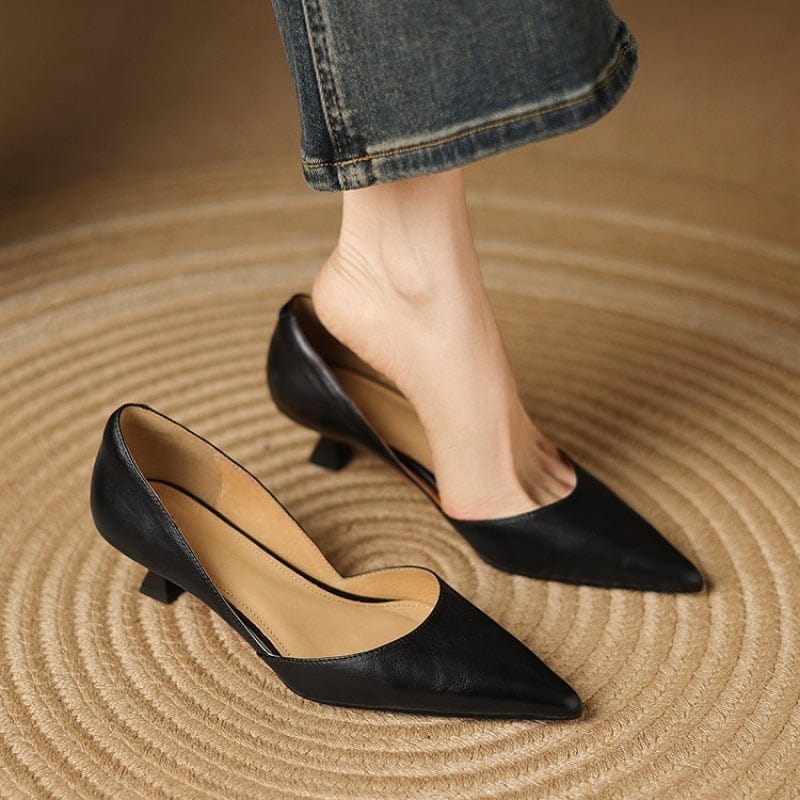 Black pointed-toe kitten heels with low block heel and smooth upper