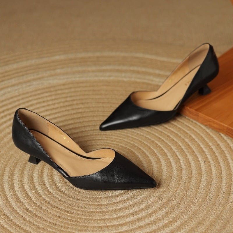 Black pointed-toe kitten heels, low block heel and curved side cutouts