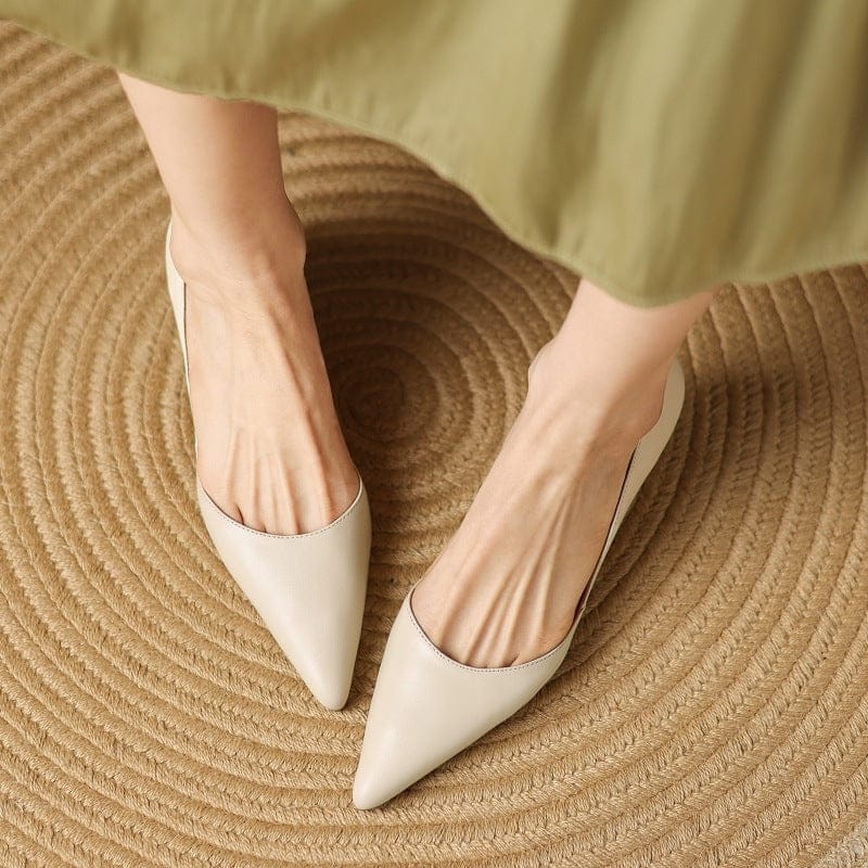 Light beige pointed-toe kitten heels with low block heel and smooth uppers