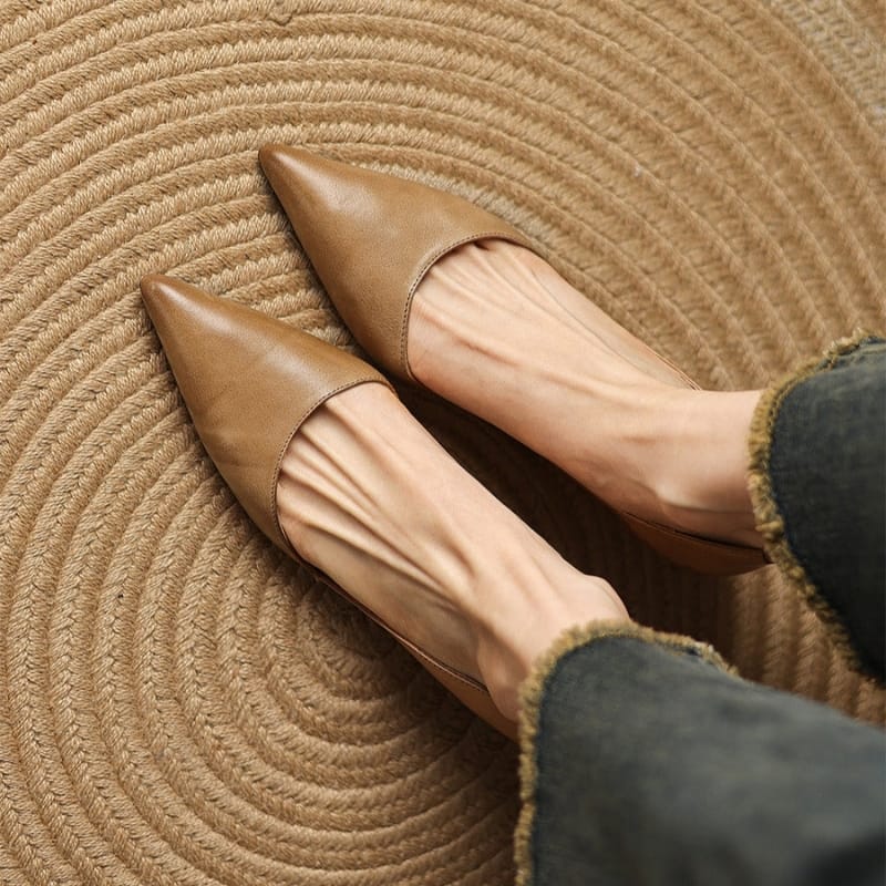 Tan pointed-toe kitten heels with low block heel and slip-on design