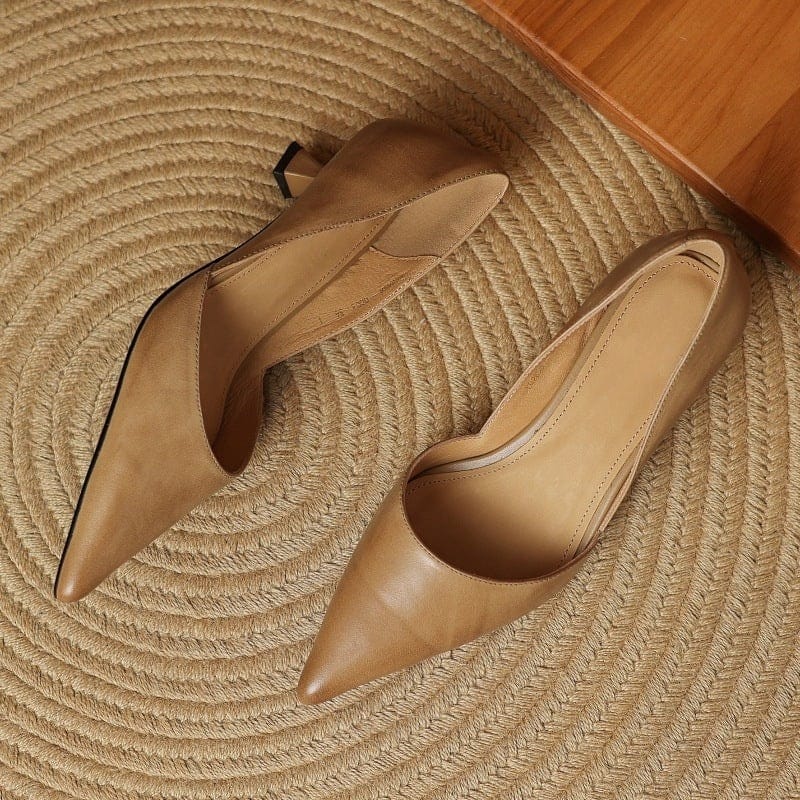 Tan pointed-toe kitten heels with low block heel and smooth upper