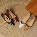 Pointed-toe kitten heels in maroon, black, white, and tan with low block heels