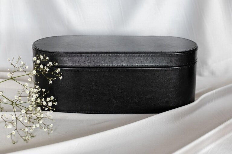 Black zip-up storage case for hair dryer brush attachments