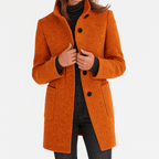 Women’s straight-cut button-front coat in burnt orange with notch collar and patch pockets.