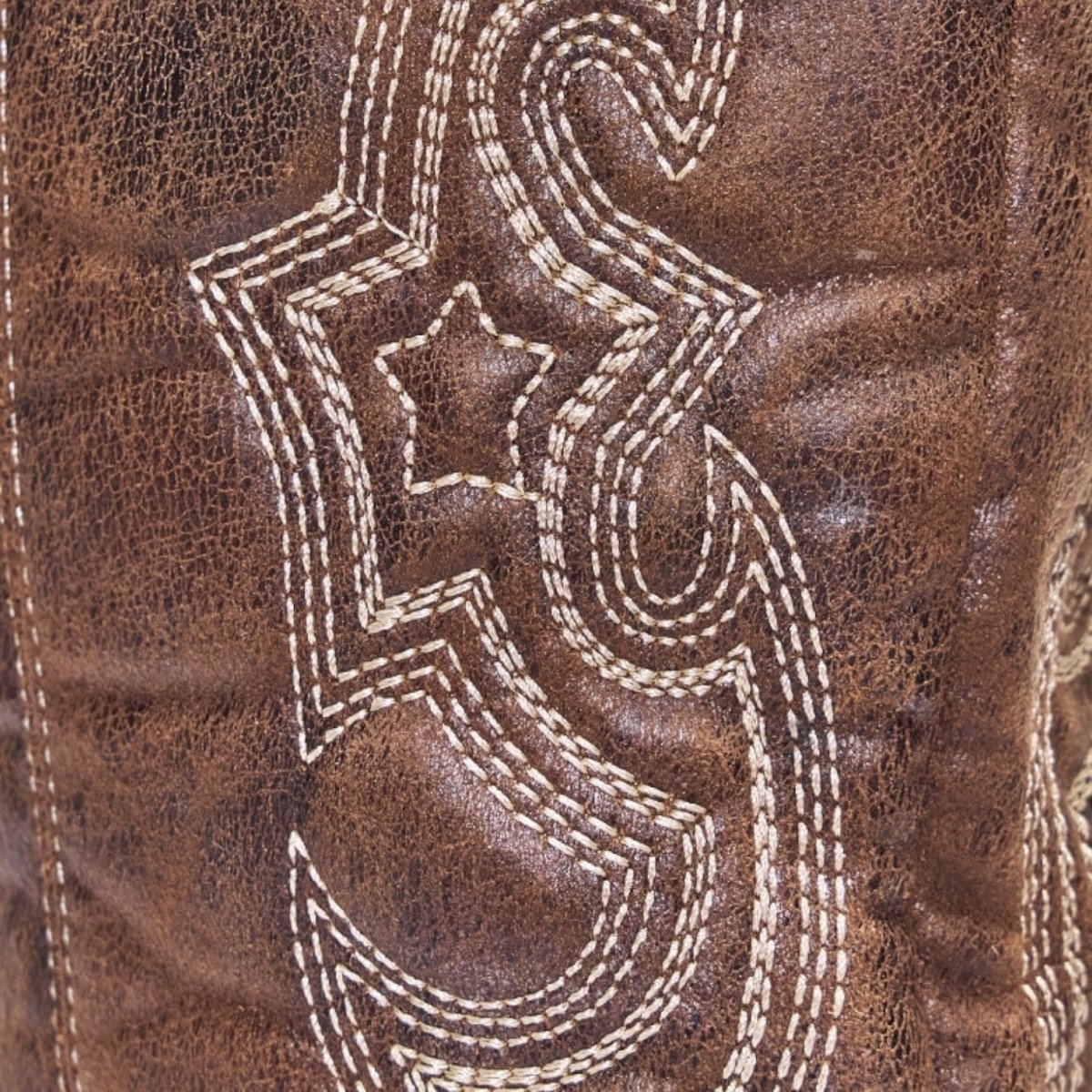 Women's brown suede western boots close-up: white contrast stitch swirl detailing